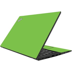 May include: A green laptop computer with the ThinkPad logo on the lid. The laptop is open and the keyboard is visible.