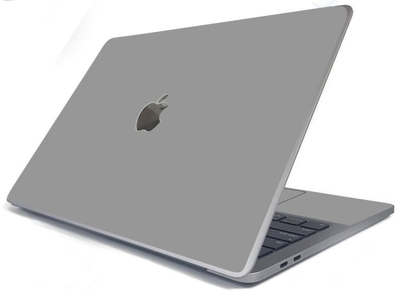 May include: A silver laptop computer with the Apple logo on the lid. The laptop is closed and the screen is facing away from the viewer.