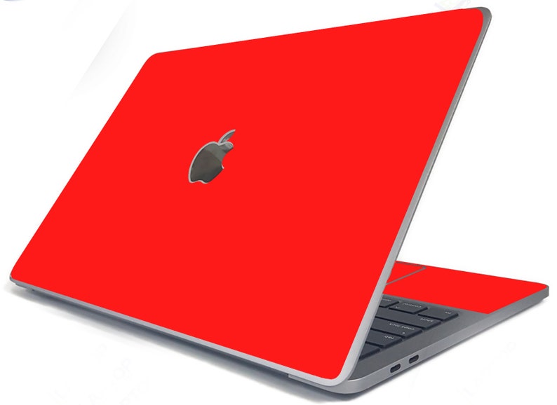 May include: A red laptop computer with a silver Apple logo on the lid. The laptop is closed and the screen is facing away from the viewer.