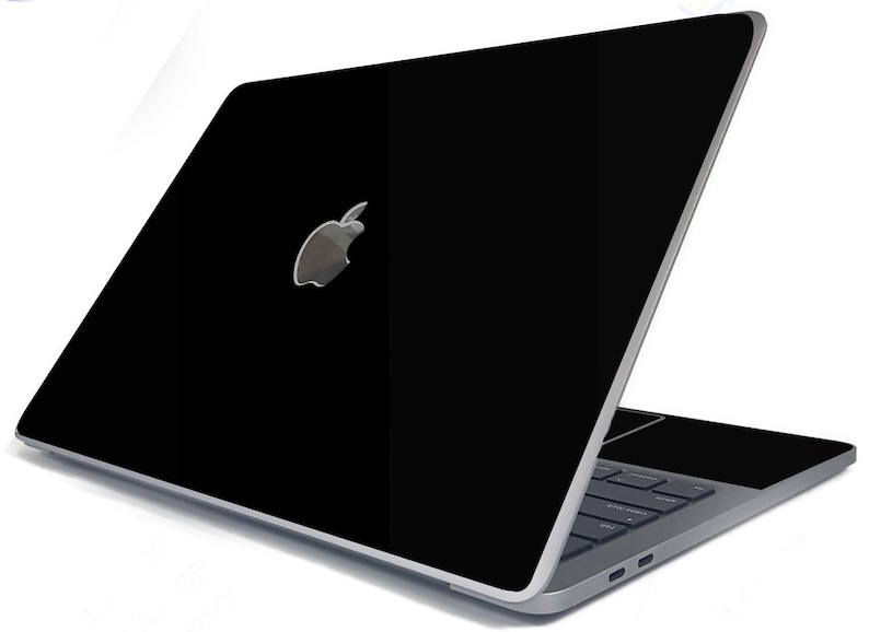 May include: A black laptop computer with a silver Apple logo on the lid. The laptop is open and the keyboard is visible.