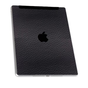 May include: Black leather iPad case with an Apple logo.