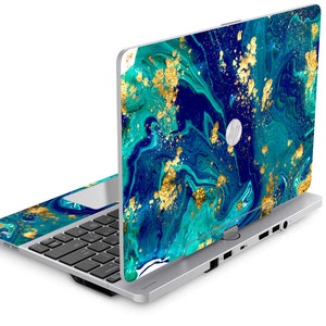 May include: A silver laptop computer with a blue and gold marbled design on the lid. The laptop is open and the keyboard is visible.