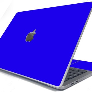 May include: A blue laptop computer with a silver Apple logo on the lid. The laptop is open and the keyboard is visible.