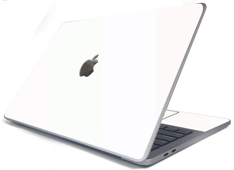 May include: A white laptop computer with a silver Apple logo on the lid. The laptop is closed and the screen is facing away from the viewer.