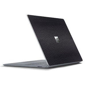 May include: A black laptop with a textured leather-like skin. The laptop is closed and the screen is facing away from the viewer.