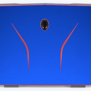 May include: A blue laptop with a red alien head logo on the lid. The logo is a stylized alien head with two red lines extending from the top of the head.