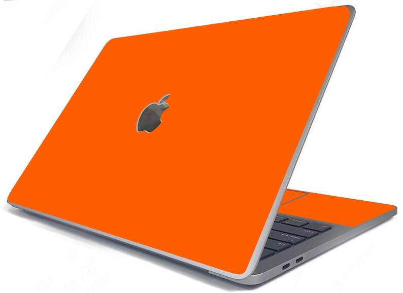 May include: A bright orange laptop with a silver Apple logo on the lid. The laptop is closed and the screen is facing away from the viewer.