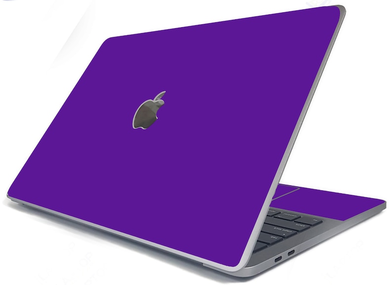 May include: A purple laptop computer with a silver Apple logo on the lid. The laptop is closed and the screen is facing away from the viewer.