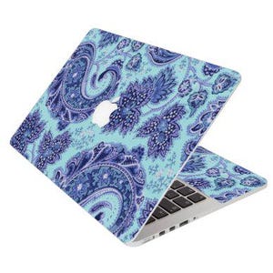 May include: A blue and purple paisley patterned laptop skin. The skin is designed to fit a MacBook laptop.