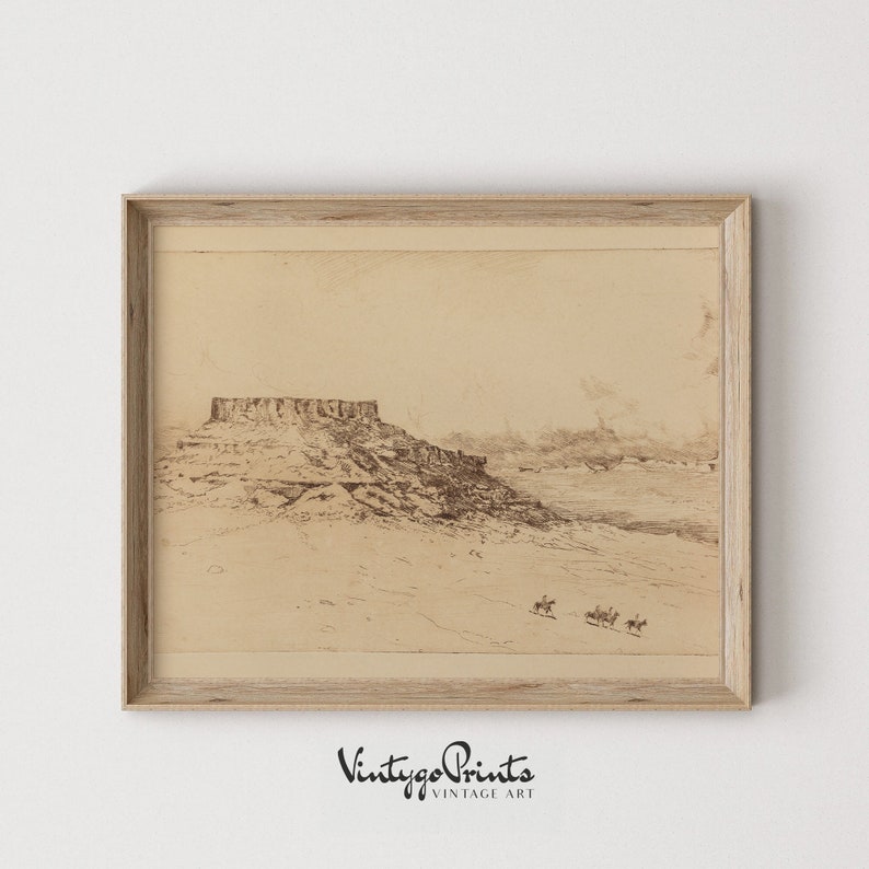 May include: A vintage black and white drawing of a desert landscape with a large rock formation in the foreground. Three figures on horseback are riding across the desert in the distance. The drawing is framed in a light wood frame.
