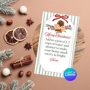 May include: A Christmas-themed gift tag with the text "Merry Christmas!" and instructions for a simmer pot. The tag is decorated with a pine cone, dried orange slices, and cinnamon sticks. The background is a warm brown with festive accents.