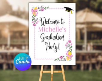 Könnte beinhalten: Ein weißes Schild auf einer Holzstaffelei, das zu einer Abschlussfeier einlädt. Auf dem Schild steht "Welcome to Michelle's Graduation Party!" in Schwarz und Rosa, mit floralen und Zitronen-Dekorationen. Oben ist eine Abschlusskappe abgebildet.