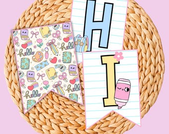 May include: A banner set with the word "HI" and a "hello" banner. The "H" is light blue, the "I" is yellow, and the "hello" banner has a pattern of school supplies, hearts, and flowers. The banners are on a woven surface.