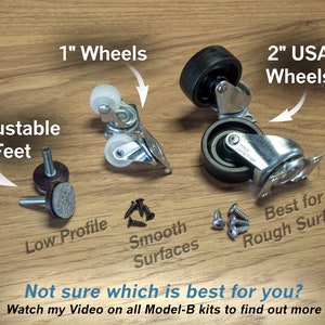 May include: A close-up of different types of furniture casters, including 1-inch wheels, 2-inch USA wheels, and adjustable feet. The text "Not sure which is best for you?" is written below the image. The text "Watch my Video on all Model-B kits to find out more" is written below the text "Not sure which is best for you?"