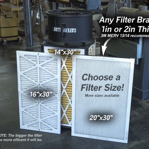 May include: A black dust collector with a filter replacement guide. The guide shows three different filter sizes: 14 inches by 30 inches, 16 inches by 30 inches, and 20 inches by 30 inches. The text on the guide says "Any Filter Brand 1in or 2in Thick 3M MERV 13/14 recommended" and "Choose a Filter Size! More sizes available".