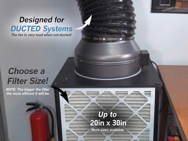 May include: A black and gray air filter system with a black flexible duct attached. The system is designed for ducted systems and can accommodate filters up to 20 inches by 30 inches. The text "Designed for DUCTED Systems" and "The fan is very loud when not ducted!" is visible in the image. The text "Choose a Filter Size!" and "NOTE: The bigger the filter the more efficient it will be." is also visible in the image. The text "Up to 20in x 30in" and "More sizes available" is visible in the image.