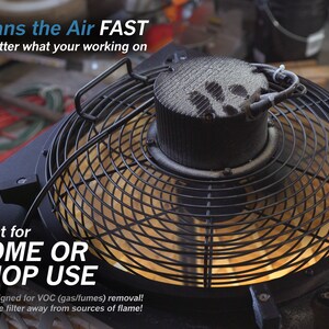 May include: A black fan with a metal grate and a white filter. The fan is on and the filter is covered in dust. The text "Cleans the Air FAST" is at the top of the image. The text "Great for HOME OR SHOP USE" is at the bottom of the image. The text "Not designed for VOC (gas/fumes) removal! Keep the filter away from sources of flame!" is below the text "Great for HOME OR SHOP USE".