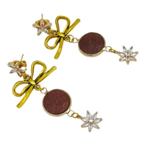 18K Gold covered cubic zirconia studs with gold bowknot pendants, genuine Agate stone pendants, and 18k covered cubic zirconia pendants.