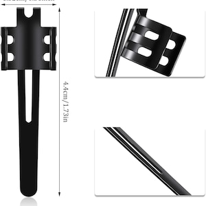 May include: Black metal phone holder with a clip on the back. The holder is 1.32 inches wide and 4.4 inches tall.