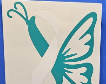 May include: Teal butterfly with white ribbon wings. The ribbon is tied in a bow at the top of the butterfly's body.