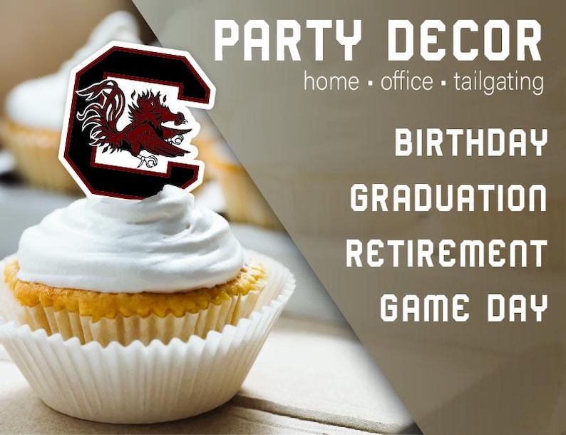 May include: A cupcake topped with white icing and a red, black and white University of South Carolina Gamecock logo. The text "PARTY DECOR" is in the background, along with the words "home - office - tailgating", "BIRTHDAY", "GRADUATION", "RETIREMENT", and "GAME DAY".