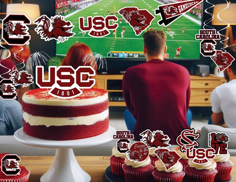 May include: A red velvet cake decorated with a University of South Carolina logo and a red and white cupcake with a Gamecock logo. The cake is on a white cake stand and the cupcakes are on a table with a red and white tablecloth. There are also several other Gamecock decorations in the background.