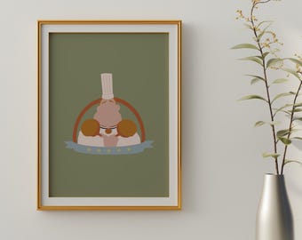 May include: A framed print with a green background featuring a cartoon chef wearing a white hat and holding two loaves of bread. The chef is surrounded by a brown circle with a blue ribbon that says "Good Food".