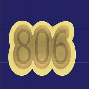 May include: A yellow sticker with the number "806" in a layered, rounded font. The numbers are in a gradient of light brown and gold, outlined in a darker brown. The background is a solid, dark blue.