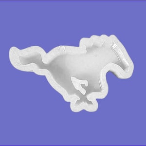 May include: A white, running horse silhouette, likely a mold or emblem, against a blue background. The horse is detailed with defined lines, suggesting a stylized design. The overall shape is smooth and rounded.