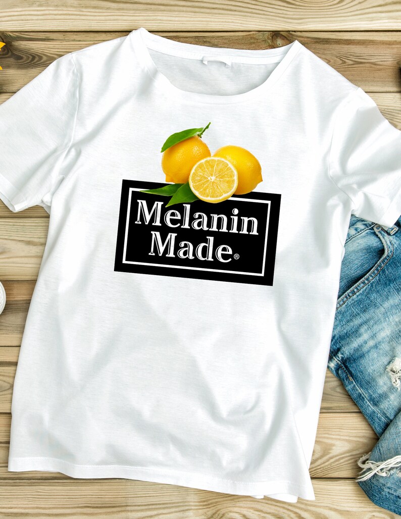 May include: White t-shirt with a graphic of lemons and the text "Melanin Made."
