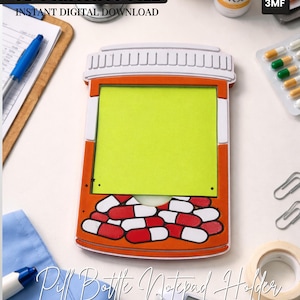 May include: A novelty pill bottle notepad holder with a bright orange frame, white and red pill design, and a yellow notepad. The text "Pill Bottle Notepad Holder" and "Ready for 3D Printing!" are visible. The image also includes the text "3D PRINTING FILE" and "INSTANT DIGITAL DOWNLOAD".