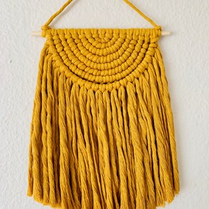 Macrame hanging of a yellow desert sun.