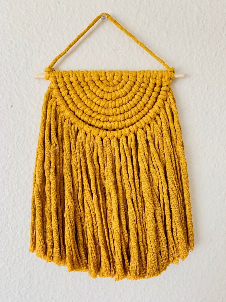 Macrame hanging of a yellow desert sun.