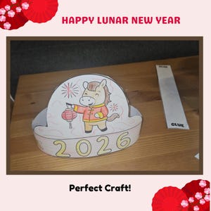 May include: A handmade paper craft for the Lunar New Year. The craft features a cartoon horse holding a lantern, with the year 2026 printed on it. The words "Happy Lunar New Year" and "Perfect Craft!" are also visible.