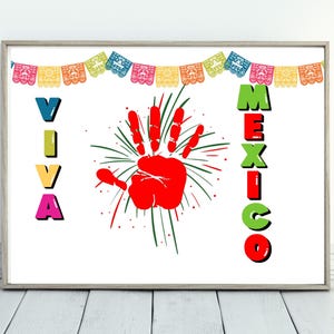 May include: A white background with a red handprint in the center. The handprint is surrounded by green and red fireworks. The words "Viva" and "Mexico" are written in colorful letters on either side of the handprint. A string of colorful paper flags hangs at the top of the image.