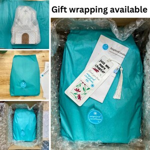 May include: A turquoise blue gift box with a white tassel bookmark that says "Just one more chapter" and a white sticker that says "Inspired Creations". The box is filled with turquoise blue tissue paper.