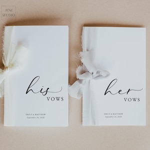 May include: Two white vow books tied with ivory ribbons. The left book reads "his vows" and the right book reads "her vows" in elegant black script. The names "EMILY & MATTHEW" and the date "September 24, 2023" are printed below the text.