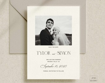 May include: A cream-coloured Save the Date card featuring a black and white photograph of a couple, with the text Tylor and Simon, are getting married, Beverly Hills, CA, September 16, 2025, and formal invitation to follow, placed in a grey envelope.