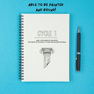 May include: A white spiral bound notebook with the text "CYCLE 1" and the question "WHAT IS THE PURPOSE OF EDUCATION?" The answer is "THE PURPOSE OF EDUCATION IS TO KNOW GOD AND MAKE HIM KNOWN". A black and white illustration of a broken column is below the text. A black pen is lying on a blue surface next to the notebook.
