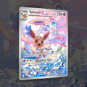May include: A holographic Sylveon Pokémon trading card. The card features a colorful illustration of Sylveon and Eevee. The card has text that reads "Mystical Return" and "Disarming Voice". The card is a Stage 1 card.