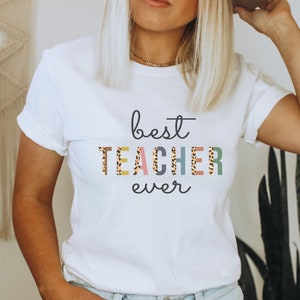 Mejor maestro de la historia estampado de guepardo, letras coloridas, camisa de maestro de regreso a la escuela.