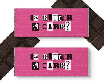 May include: Two pink chocolate bar wrappers with the text "IS BUTTER A CARB?" in black and white letters. The wrappers are printed with a pink background and white text.