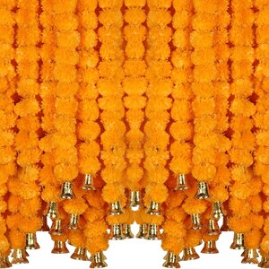 May include: A garland of bright yellow marigold flowers with gold bells hanging from the bottom. The garland is made of artificial flowers and is ideal for decorating for a festival or celebration.