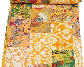 Puede incluir: Un edredón de patchwork con una vibrante mezcla de patrones florales y geométricos en tonos amarillos, naranjas y blancos. El edredón está doblado, mostrando la variedad de diseños y texturas. Las costuras son visibles, lo que añade a la estética artesanal.