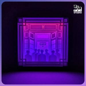 May include: A square, layered paper light box featuring a purple and pink glow. The design depicts a doorway with a sign in Korean characters, and the silhouettes of seven figures standing in front. The top right corner displays the text AJA ART STUDIO.