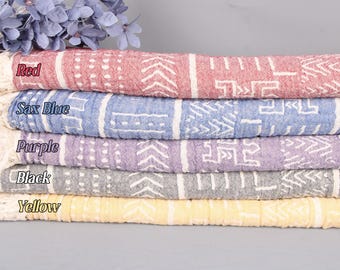 May include: Five cotton towels stacked on top of each other. The towels are in different colors: red, blue, purple, gray, and yellow. Each towel has a white geometric pattern.