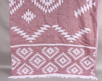 May include: A maroon and white patterned textile with a geometric design. The fabric features repeating white diamond and zig-zag shapes against a maroon background. The bottom edge has a white fringe.