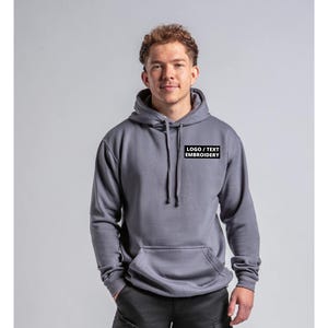 May include: A grey hooded sweatshirt with a black rectangle on the chest that says "LOGO / TEXT EMBROIDERY".