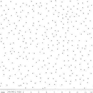 May include: White fabric with a scattered pattern of small, dark blue dots. The dots are evenly distributed across the surface. The fabric has a smooth texture and is suitable for various sewing projects. The image includes a ruler with inches.