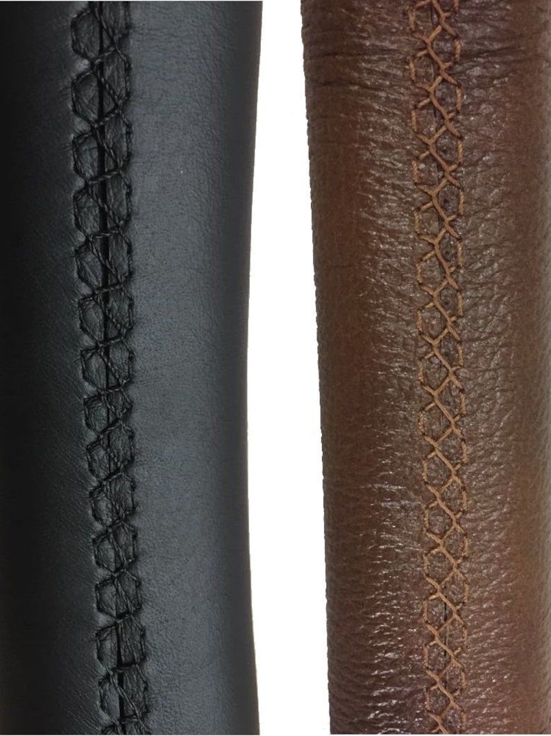 May include: Two close-up images of leather steering wheel covers. The left image shows a black leather cover with black stitching. The right image shows a brown leather cover with brown stitching.